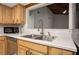 Kitchen area showing a sink, white countertops, and wood cabinets at 200 Maitland Ave # 86, Altamonte Springs, FL 32701