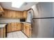 Kitchen featuring wood cabinets, stainless steel appliances, and white countertops at 200 Maitland Ave # 86, Altamonte Springs, FL 32701