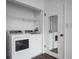 A laundry closet features side by side washer and dryer, shelving, and a mirrored door at 200 Maitland Ave # 86, Altamonte Springs, FL 32701