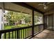 Patio featuring wood railing with a view of lush lawn, landscaping, and trees at 200 Maitland Ave # 86, Altamonte Springs, FL 32701