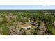 An aerial view shows a home nestled among a dense forest, offering privacy at 20240 Sw 95Th St, Dunnellon, FL 34431