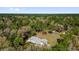 Stunning aerial view of a charming home nestled within lush green forest trees at 20240 Sw 95Th St, Dunnellon, FL 34431