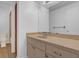 Bathroom featuring a beige vanity, neutral walls, and a doorway to an adjacent room at 20240 Sw 95Th St, Dunnellon, FL 34431