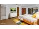 Bedroom with parquet flooring, a large bed, a modern dresser, and sliding doors to an outdoor space at 20240 Sw 95Th St, Dunnellon, FL 34431