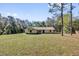 Sprawling property featuring a well-kept lawn and a single-story home at 20240 Sw 95Th St, Dunnellon, FL 34431