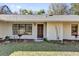 Inviting front entrance featuring a dark wooden door and manicured garden at 20240 Sw 95Th St, Dunnellon, FL 34431