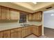 Kitchen with light countertops, a double stainless steel sink and wooden cabinets at 20240 Sw 95Th St, Dunnellon, FL 34431
