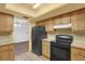 Kitchen featuring wood cabinets, laminate countertops and black appliances at 20240 Sw 95Th St, Dunnellon, FL 34431