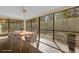 Enclosed patio with a ceiling fan, views of the backyard, and a light brick floor, perfect for entertaining at 20240 Sw 95Th St, Dunnellon, FL 34431