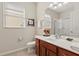 Bathroom with a wood cabinet vanity, toilet and glass enclosed shower at 2508 Archfeld Blvd, Kissimmee, FL 34747