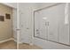 Bright bathroom with a tub, glass-enclosed shower and linen closet at 2508 Archfeld Blvd, Kissimmee, FL 34747
