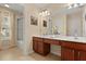 Bright bathroom features a double vanity with drawers and a glass-enclosed shower at 2508 Archfeld Blvd, Kissimmee, FL 34747