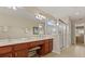 Bathroom featuring double vanity with wood cabinets, walk-in shower, and tiled floors at 2508 Archfeld Blvd, Kissimmee, FL 34747