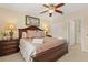 Comfortable bedroom featuring a king-size bed, ceiling fan and wood furniture at 2508 Archfeld Blvd, Kissimmee, FL 34747