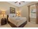 Comfortable bedroom features plush bedding, side tables with lamps, and natural light from the window at 2508 Archfeld Blvd, Kissimmee, FL 34747