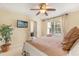 Bright bedroom featuring a TV, ceiling fan, and a window letting in lots of natural light at 2508 Archfeld Blvd, Kissimmee, FL 34747