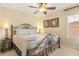 This comfortable bedroom features a ceiling fan, and gets plenty of natural light at 2508 Archfeld Blvd, Kissimmee, FL 34747