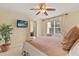 Bedroom with a TV, ceiling fan, large window, and comfortable bedding at 2508 Archfeld Blvd, Kissimmee, FL 34747