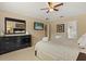 Spacious bedroom showing large dresser, TV, and doorway to en suite bathroom at 2508 Archfeld Blvd, Kissimmee, FL 34747