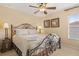 Bedroom features a queen-size bed, bedside tables with lamps, and a window with natural light at 2508 Archfeld Blvd, Kissimmee, FL 34747
