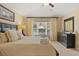 Well-lit bedroom featuring a king-size bed, dresser, and window with outside views at 2508 Archfeld Blvd, Kissimmee, FL 34747