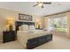 Bright bedroom features a king-size bed, ceiling fan, and large window for ample natural light at 2508 Archfeld Blvd, Kissimmee, FL 34747