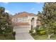 Stunning two-story home boasting a barrel tile roof, manicured landscaping, and a welcoming front entrance at 2508 Archfeld Blvd, Kissimmee, FL 34747