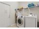 Convenient laundry room with washer, dryer, shelving, and storage space at 2508 Archfeld Blvd, Kissimmee, FL 34747