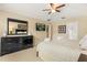 This main bedroom features an entertainment center, large mirror, and neutral tones at 2508 Archfeld Blvd, Kissimmee, FL 34747