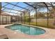 Beautiful screened-in pool and spa with brick paved deck and manicured lawn at 2508 Archfeld Blvd, Kissimmee, FL 34747