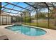 Inviting pool with a screened enclosure and brick-paved deck at 2508 Archfeld Blvd, Kissimmee, FL 34747