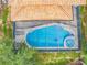 Aerial view of a private screened in pool and spa with a beautiful tile roof on the house at 2548 Archfeld Blvd, Kissimmee, FL 34747