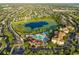 Community aerial view of a resort-style pool, waterslide, pond, and surrounding neighborhood at 2548 Archfeld Blvd, Kissimmee, FL 34747