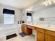 Bathroom featuring a garden tub, double sink vanity, and large mirror at 2548 Archfeld Blvd, Kissimmee, FL 34747