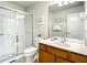 Well-lit bathroom with a glass door shower, a modern sink, and a decorative mirror at 2548 Archfeld Blvd, Kissimmee, FL 34747
