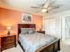 Bedroom featuring ceiling fan, two nightstands, a picture window and closet at 2548 Archfeld Blvd, Kissimmee, FL 34747