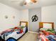 Bright bedroom with twin beds, superhero bedding, and a ceiling fan at 2548 Archfeld Blvd, Kissimmee, FL 34747