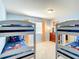 Bedroom with 2 sets of bunk beds with blue bedding with Disney characters at 2548 Archfeld Blvd, Kissimmee, FL 34747