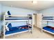 Bedroom with 2 sets of bunk beds with blue bedding with Disney characters at 2548 Archfeld Blvd, Kissimmee, FL 34747