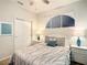 Bedroom with queen bed and white nightstands plus modern art displayed above the bed at 2548 Archfeld Blvd, Kissimmee, FL 34747
