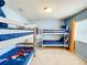 Bedroom with 2 sets of bunk beds with blue bedding with Disney characters at 2548 Archfeld Blvd, Kissimmee, FL 34747
