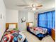 Bedroom featuring twin beds, superhero bedding, a ceiling fan, and ample natural light at 2548 Archfeld Blvd, Kissimmee, FL 34747