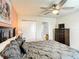 Bedroom featuring ceiling fan, dresser, a view to ensuite bath, and a closet at 2548 Archfeld Blvd, Kissimmee, FL 34747
