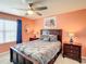 Bedroom featuring ceiling fan, two nightstands, and a picture window at 2548 Archfeld Blvd, Kissimmee, FL 34747