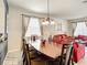 Dining room with a large table, chandelier, and view to the living room at 2548 Archfeld Blvd, Kissimmee, FL 34747