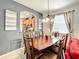 Open concept dining room with a large table and view into the kitchen at 2548 Archfeld Blvd, Kissimmee, FL 34747