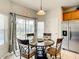 Cozy dining area adjacent to the stainless steel refrigerator and patio access to the pool at 2548 Archfeld Blvd, Kissimmee, FL 34747