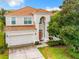Stunning two-story home featuring a red tile roof, well-manicured lawn, and a two car garage at 2548 Archfeld Blvd, Kissimmee, FL 34747