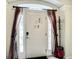 Foyer entrance featuring a white door with sidelights and decorative curtains at 2548 Archfeld Blvd, Kissimmee, FL 34747