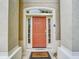 Close-up of the front door with decorative sidelights and a welcome mat at 2548 Archfeld Blvd, Kissimmee, FL 34747